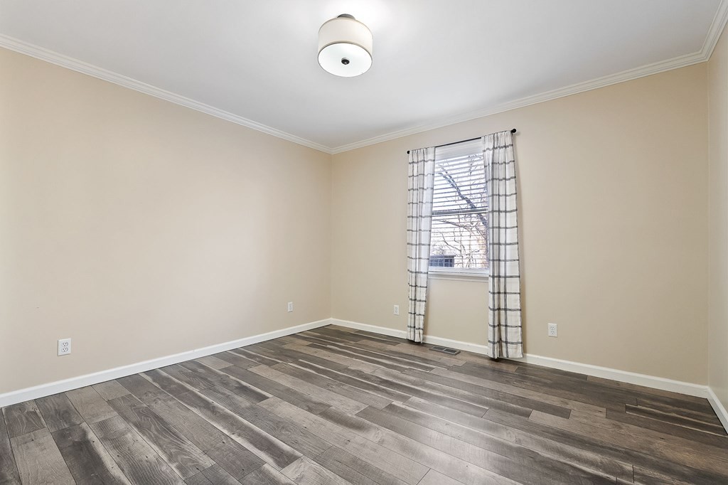 7927 Rocky Point Road Cookeville, TN 38506 - Photo 13 of 26 an empty room with wooden floor and windows