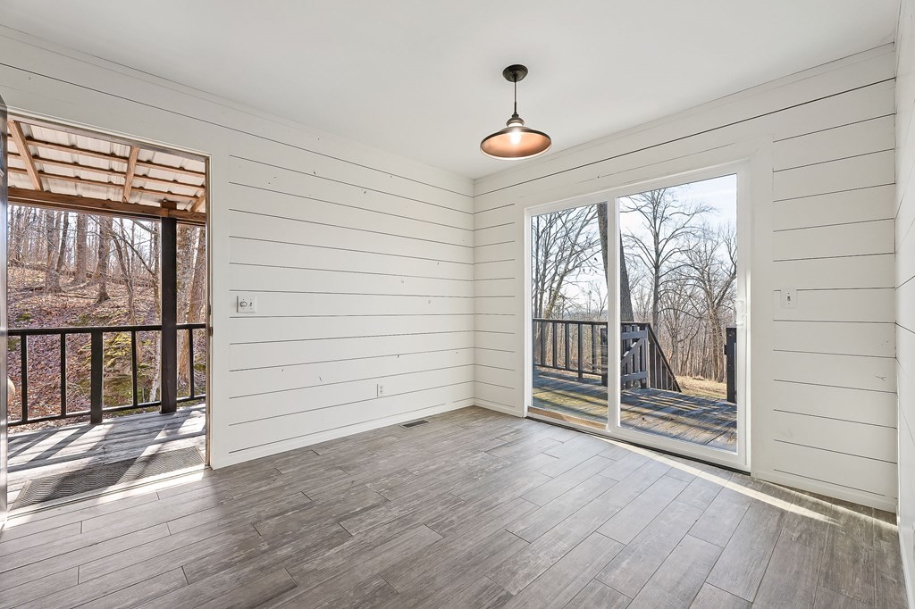 7927 Rocky Point Road Cookeville, TN 38506 - Photo 18 of 26 an empty room with wooden floor and windows
