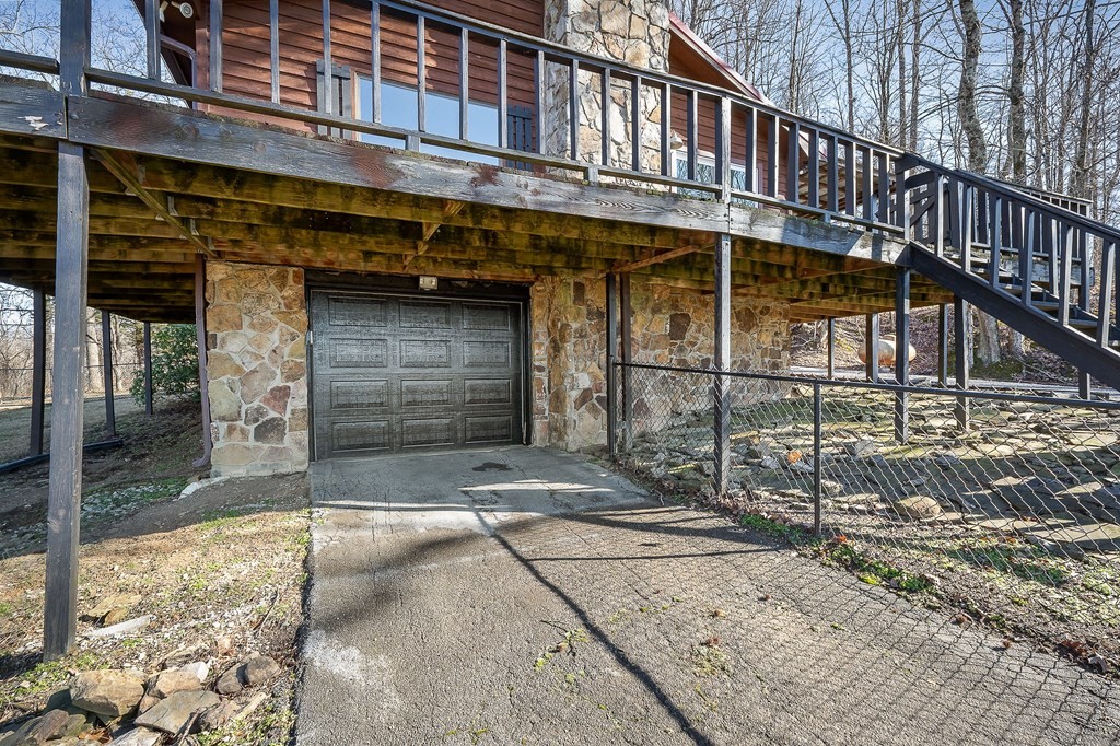 7927 Rocky Point Road Cookeville, TN 38506 - Photo 25 of 26 a front view of a building with a garage