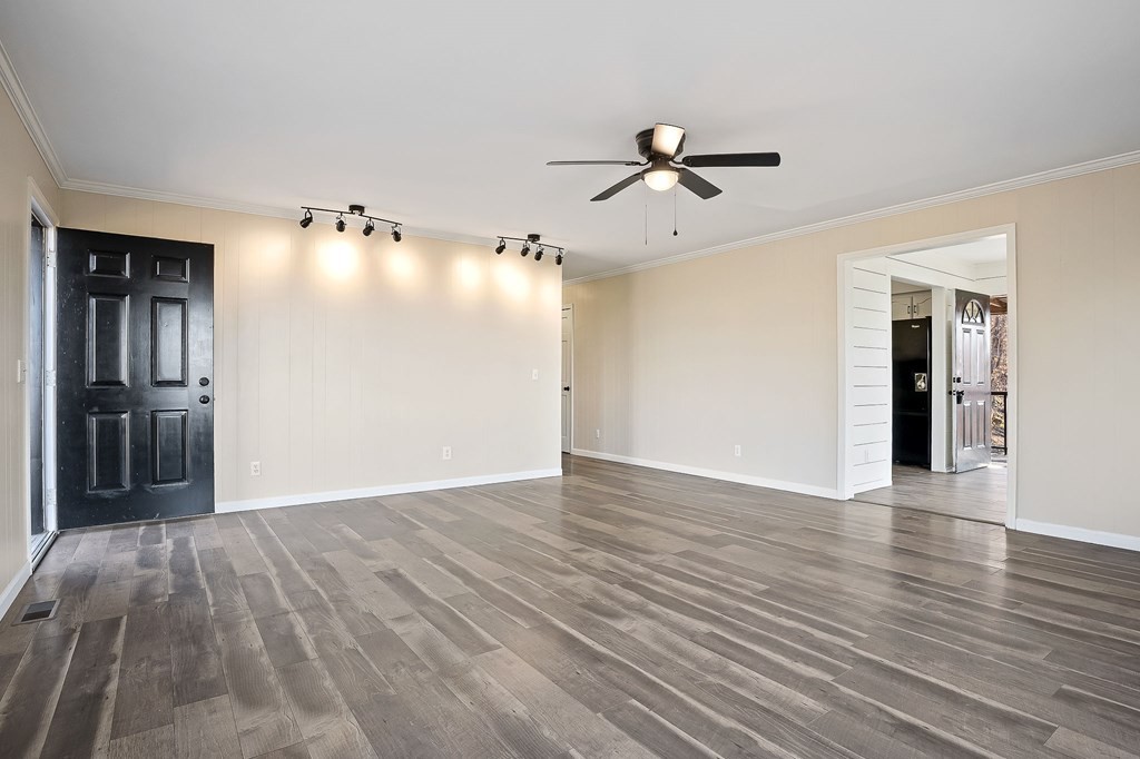 7927 Rocky Point Road Cookeville, TN 38506 - Photo 3 of 26 a view of empty room with wooden floor and fan