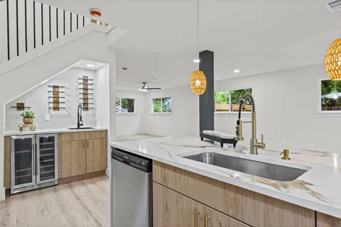 a kitchen with a sink cabinets and window