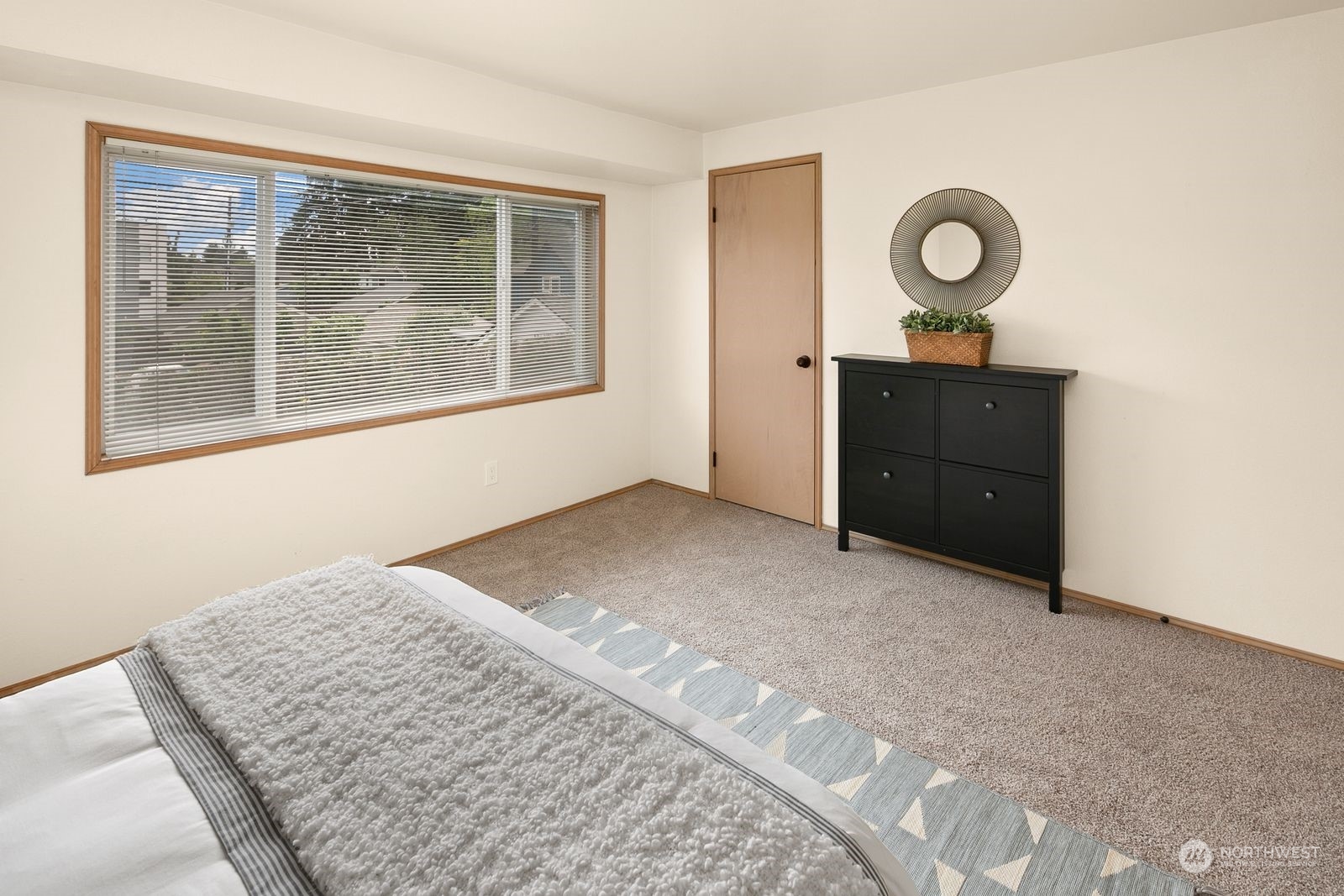 5421 Fauntleroy Way Southwest, Unit A Seattle, WA 98136 - Photo 11 of 18 a view of a bedroom with wooden floor and windows