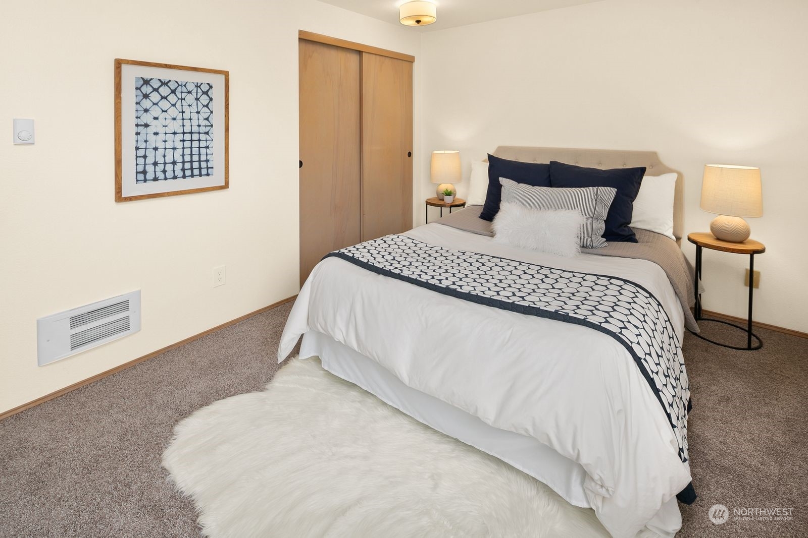 5421 Fauntleroy Way Southwest, Unit A Seattle, WA 98136 - Photo 12 of 18 a bedroom with a bed and a night stand