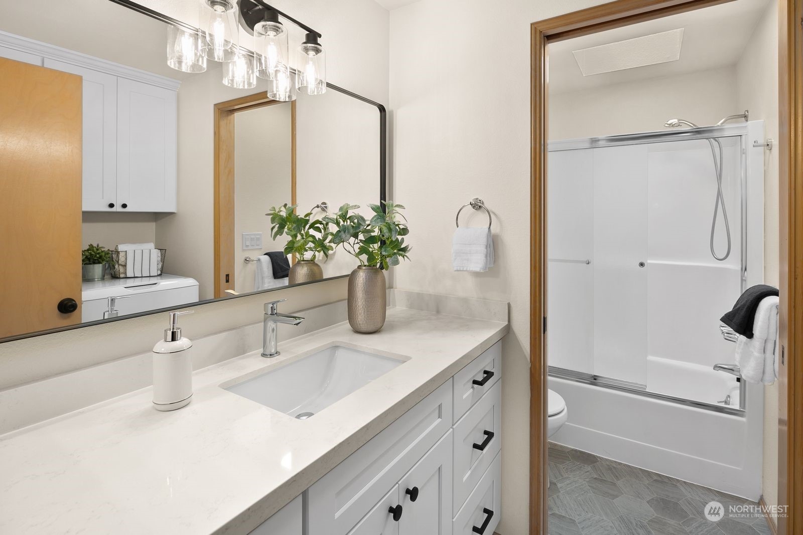 5421 Fauntleroy Way Southwest, Unit A Seattle, WA 98136 - Photo 13 of 18 a bathroom with a sink and a mirror