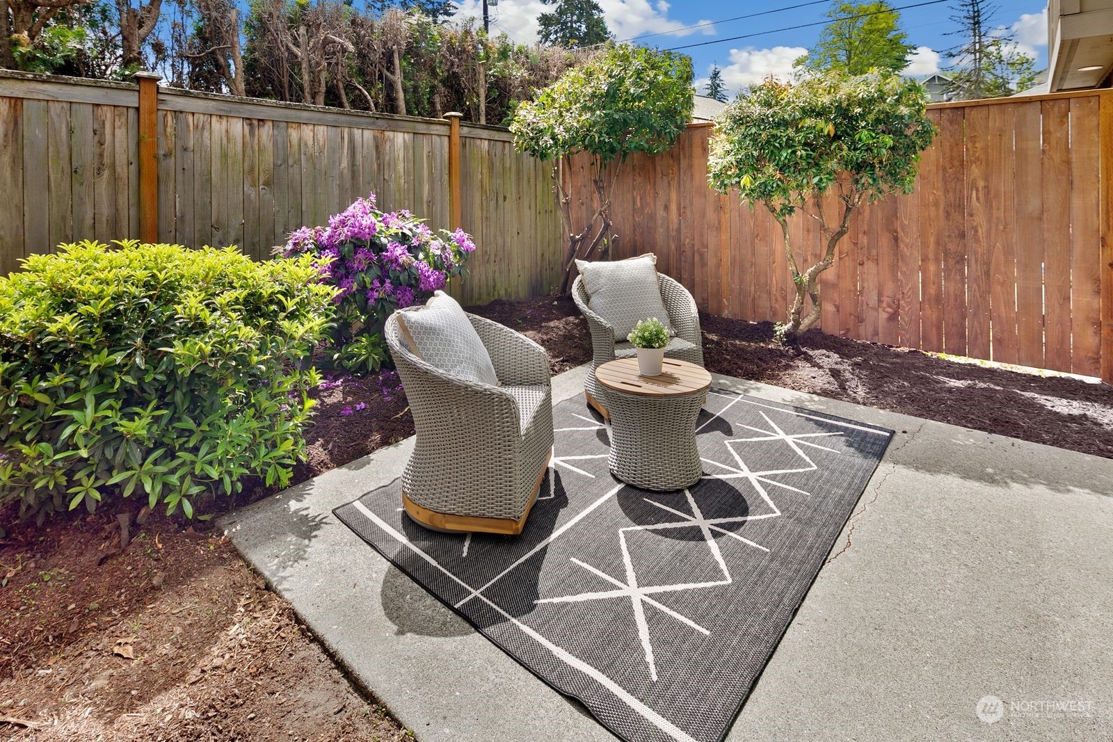 5421 Fauntleroy Way Southwest, Unit A Seattle, WA 98136 - Photo 16 of 18 a view of a chairs and table in the back yard of a house