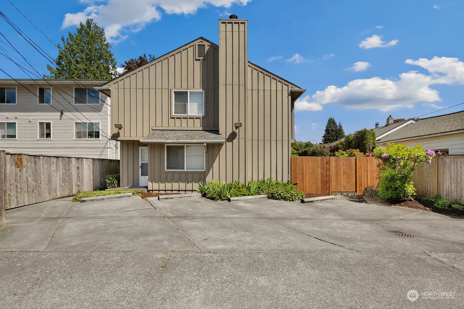5421 Fauntleroy Way Southwest, Unit A Seattle, WA 98136 - Photo 18 of 18 a view of a house with a yard and potted plants