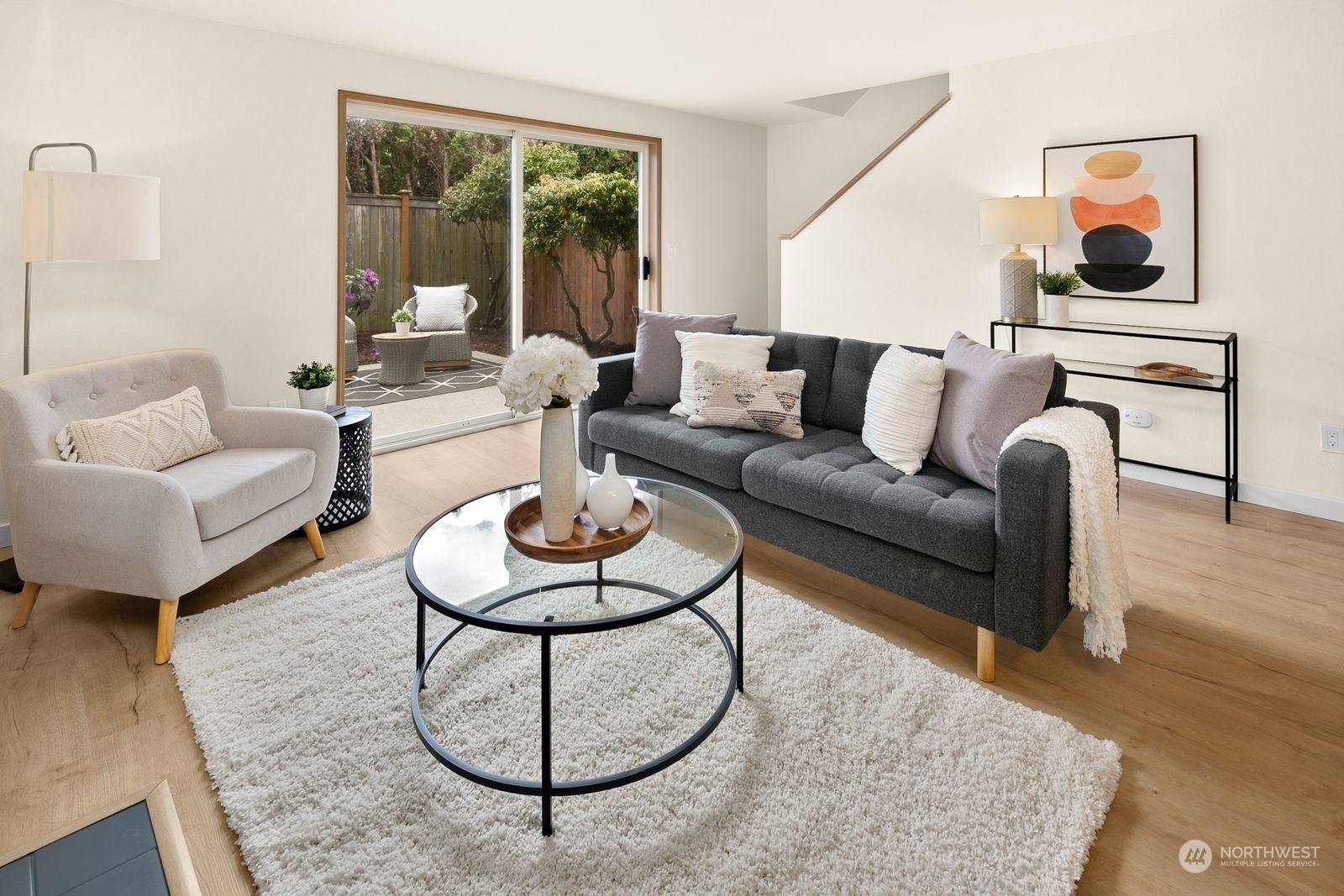 5421 Fauntleroy Way Southwest, Unit A Seattle, WA 98136 - Photo 2 of 18 a living room with furniture a rug and a large window