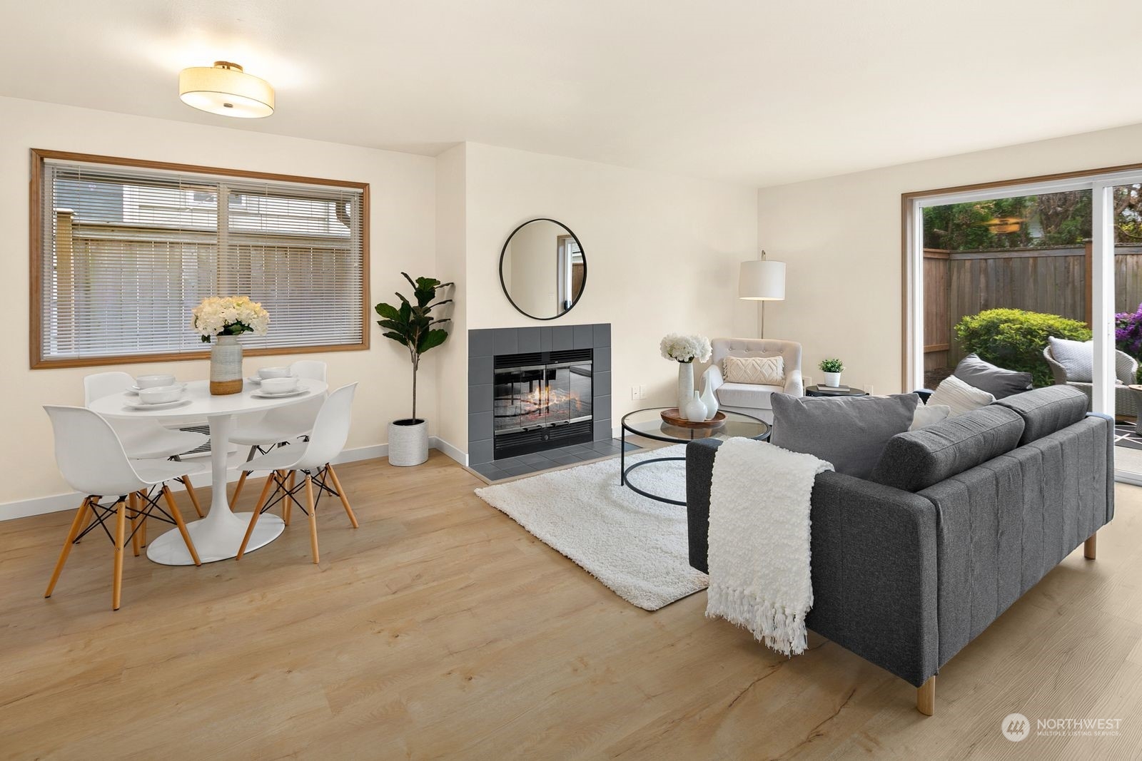 5421 Fauntleroy Way Southwest, Unit A Seattle, WA 98136 - Photo 3 of 18 a living room with furniture a fireplace and a flat screen tv