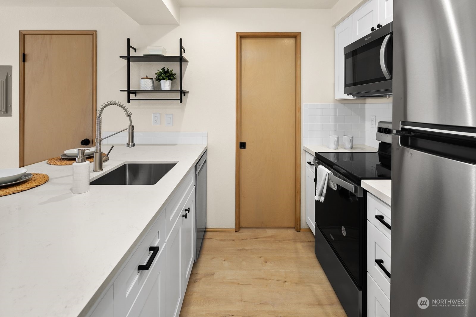 5421 Fauntleroy Way Southwest, Unit A Seattle, WA 98136 - Photo 5 of 18 a kitchen with a sink and a refrigerator