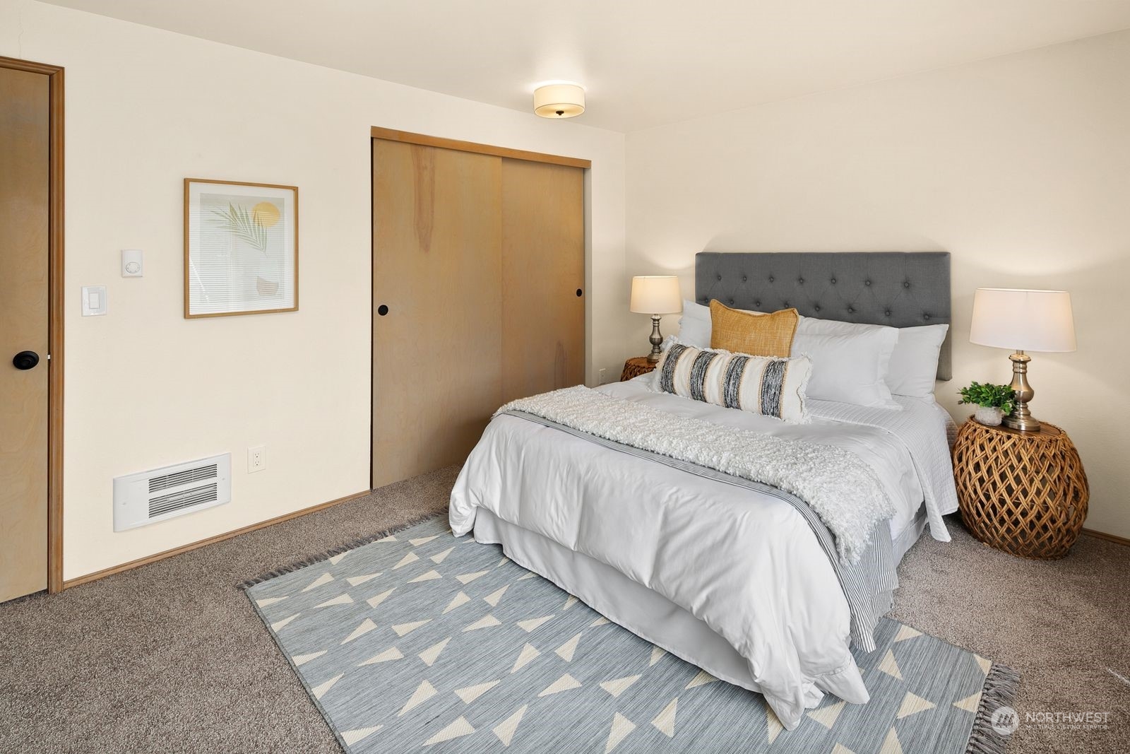 5421 Fauntleroy Way Southwest, Unit A Seattle, WA 98136 - Photo 10 of 18 a bedroom with a bed and a painting on the wall