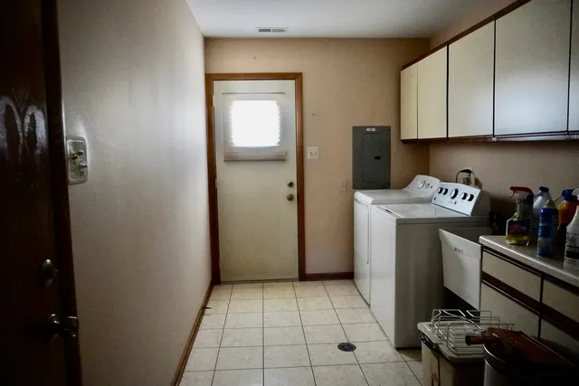a kitchen with refrigerator and cabinets