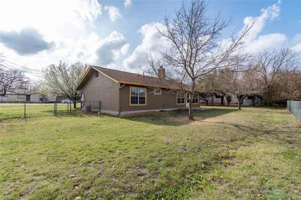 a view of backyard of house with green space
