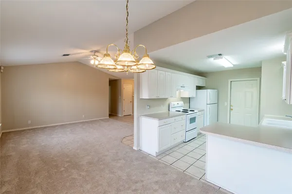 a view of a kitchen with sink and microwave