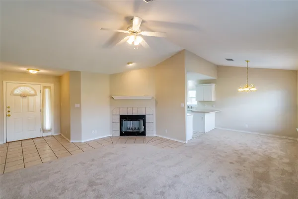 a view of an empty room and fire place