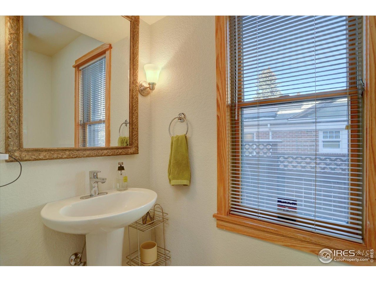 815 16th Street Boulder, CO 80302 - Photo 13 of 47 a bathroom with a sink a mirror and shower
