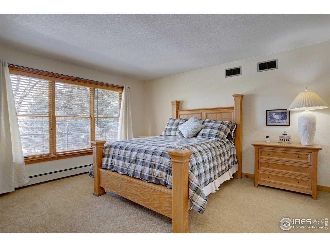 815 16th Street Boulder, CO 80302 - Photo 24 of 47 a bedroom with a bed and a large window