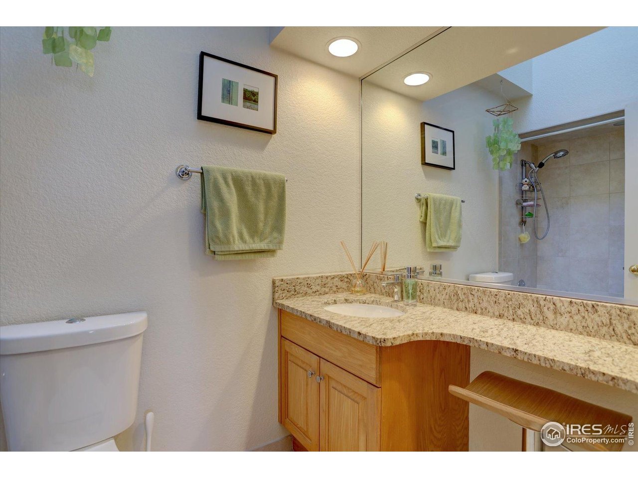 815 16th Street Boulder, CO 80302 - Photo 26 of 47 a bathroom with a granite countertop sink a mirror and a toilet