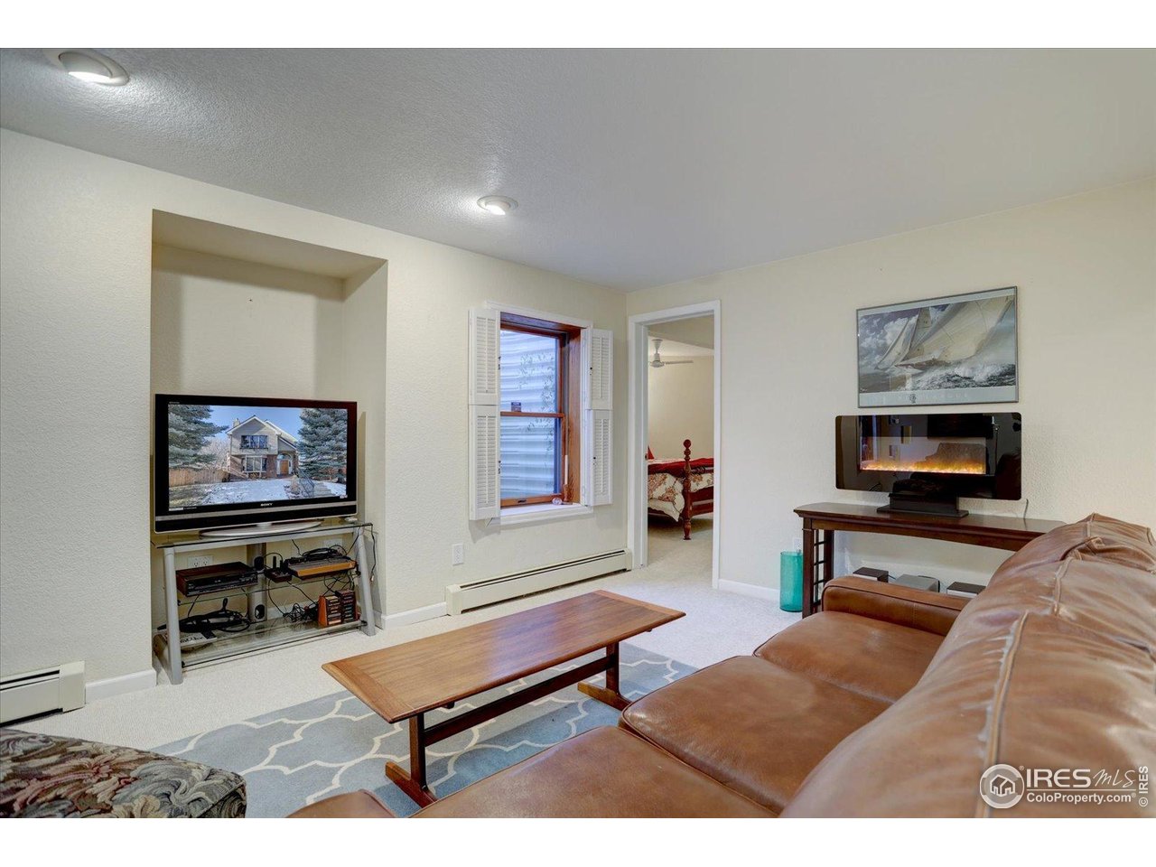 815 16th Street Boulder, CO 80302 - Photo 28 of 47 a living room with furniture a flat screen tv and a wall paintings