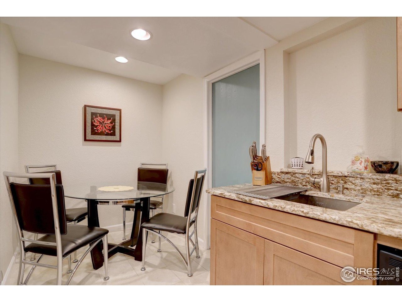 815 16th Street Boulder, CO 80302 - Photo 35 of 47 a room with a table chairs and a refrigerator