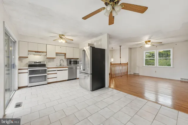 a kitchen with stainless steel appliances a refrigerator and a stove top oven