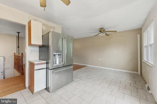 a view of a kitchen with a refrigerator and a sink
