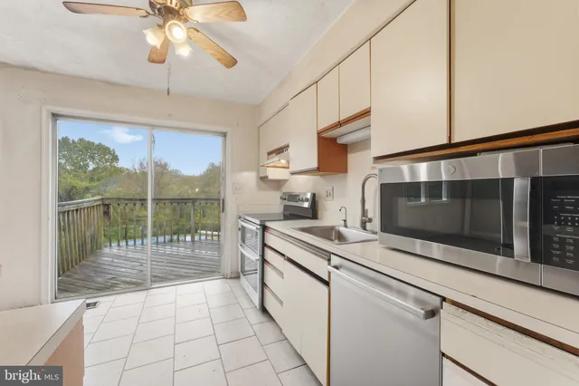 a kitchen with a stove a sink and a microwave