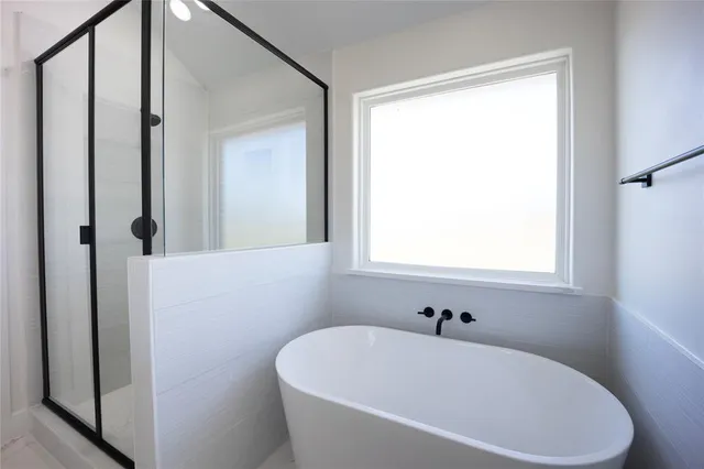 a white bath tub sitting next to a white sink