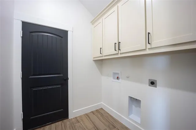 a large kitchen with stainless steel appliances a large counter top a stove a sink and a refrigerator