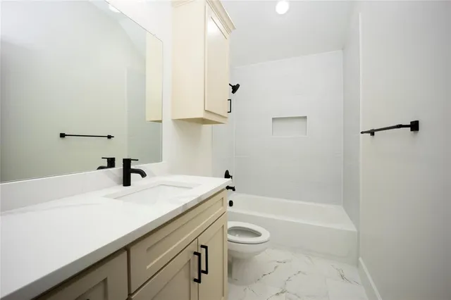 a bathroom with a sink a toilet and a bathtub