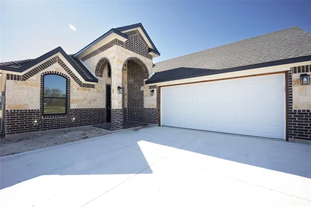 a front view of a house with parking area