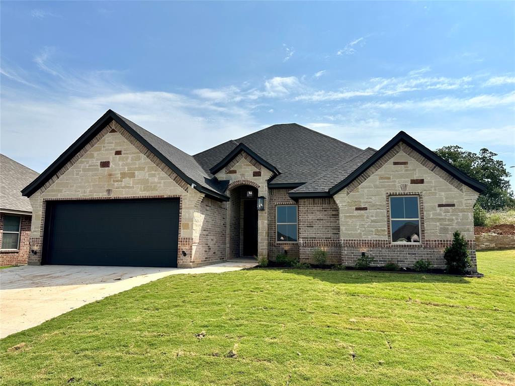 a front view of a house with a yard and garage