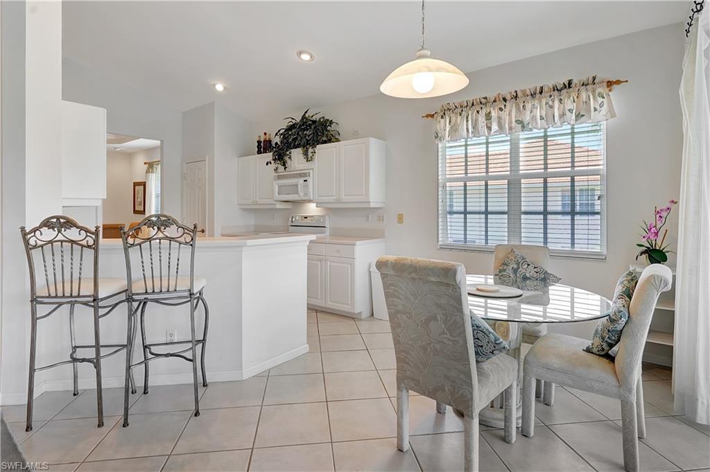 23156 Rosedale Drive, Unit 201 Estero, FL 34135 - Photo 11 of 50 a dining room with furniture and window
