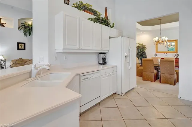 a kitchen with a sink cabinets and appliances