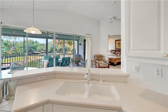 a kitchen with a sink and a large window