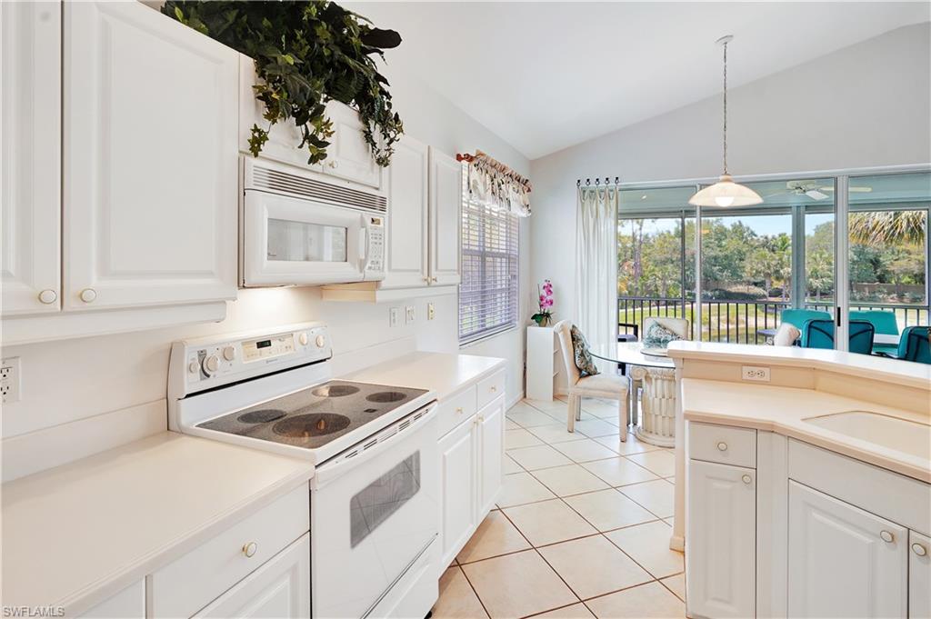 23156 Rosedale Drive, Unit 201 Estero, FL 34135 - Photo 16 of 50 a kitchen that has a stove a sink and a refrigerator