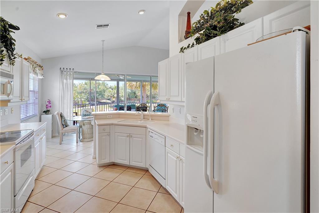 23156 Rosedale Drive, Unit 201 Estero, FL 34135 - Photo 17 of 50 a kitchen with white cabinets and white appliances