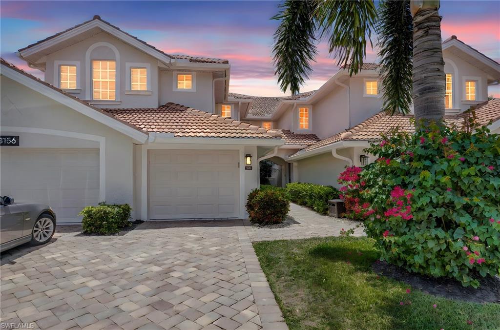23156 Rosedale Drive, Unit 201 Estero, FL 34135 - Photo 2 of 50 a front view of a house with a yard