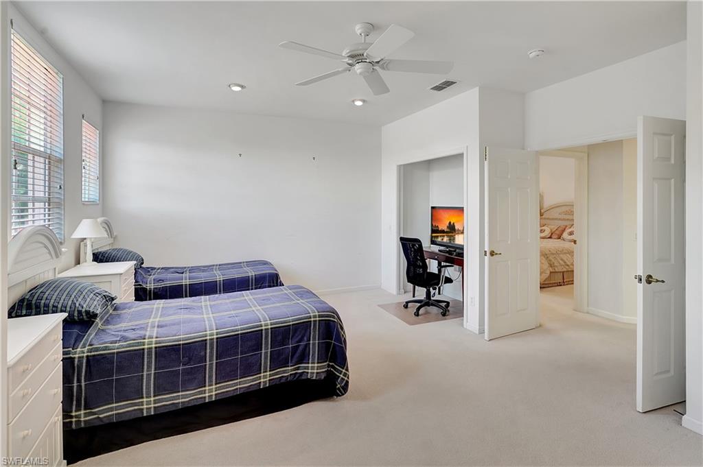 23156 Rosedale Drive, Unit 201 Estero, FL 34135 - Photo 25 of 50 a bedroom with a bed and a cabinets