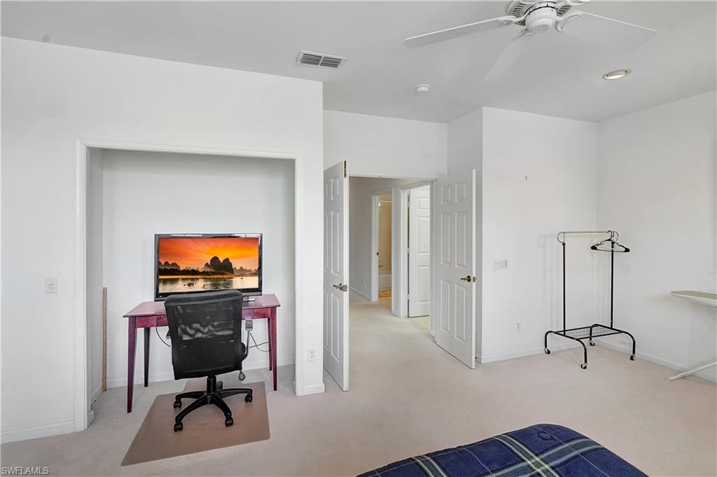 23156 Rosedale Drive, Unit 201 Estero, FL 34135 - Photo 27 of 50 a view of a workspace with furniture and a flat screen tv
