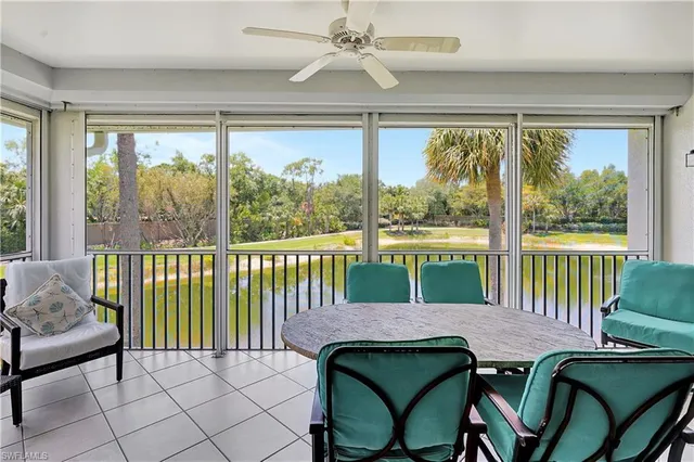 a view of a dining room with furniture large windows and wooden floor
