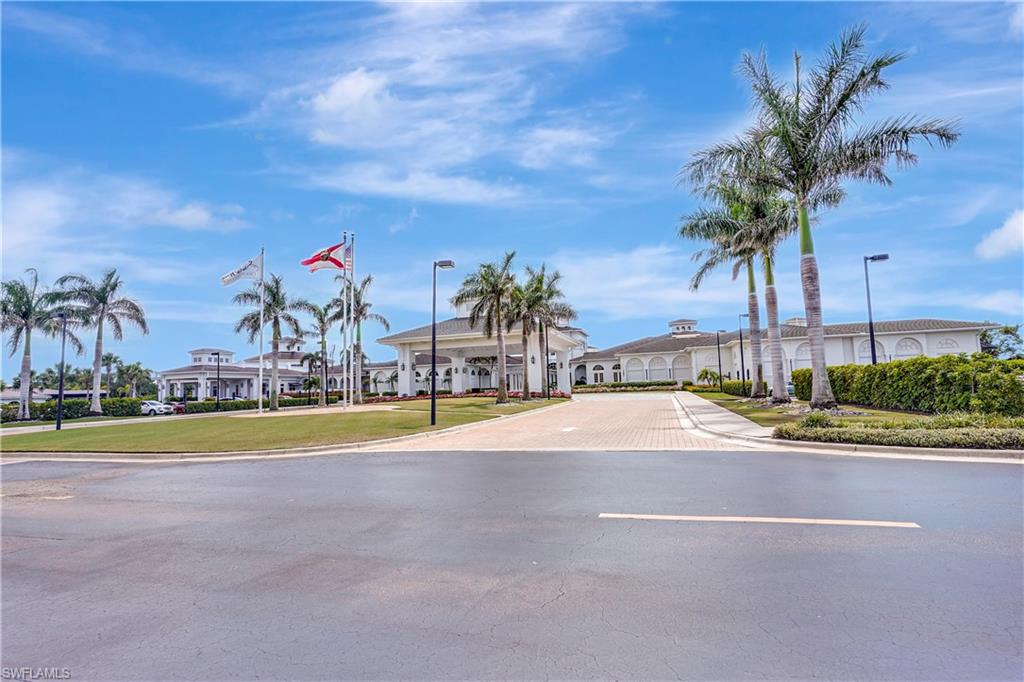 23156 Rosedale Drive, Unit 201 Estero, FL 34135 - Photo 40 of 50 a view of a swimming pool with a yard and palm trees