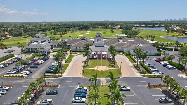 an aerial view of ocean and residential houses with outdoor space