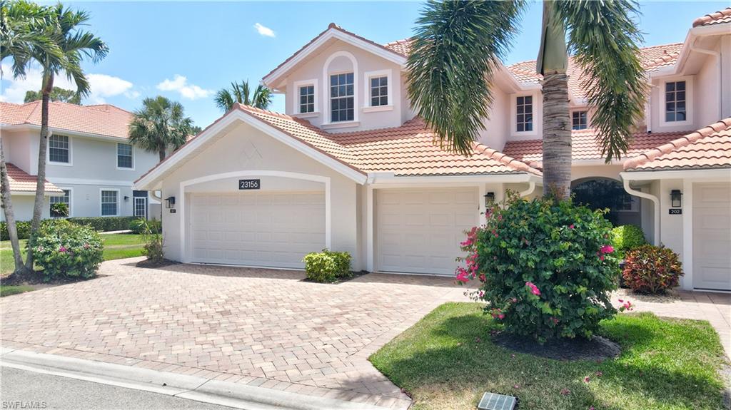 23156 Rosedale Drive, Unit 201 Estero, FL 34135 - Photo 49 of 50 a front view of a house with a garden