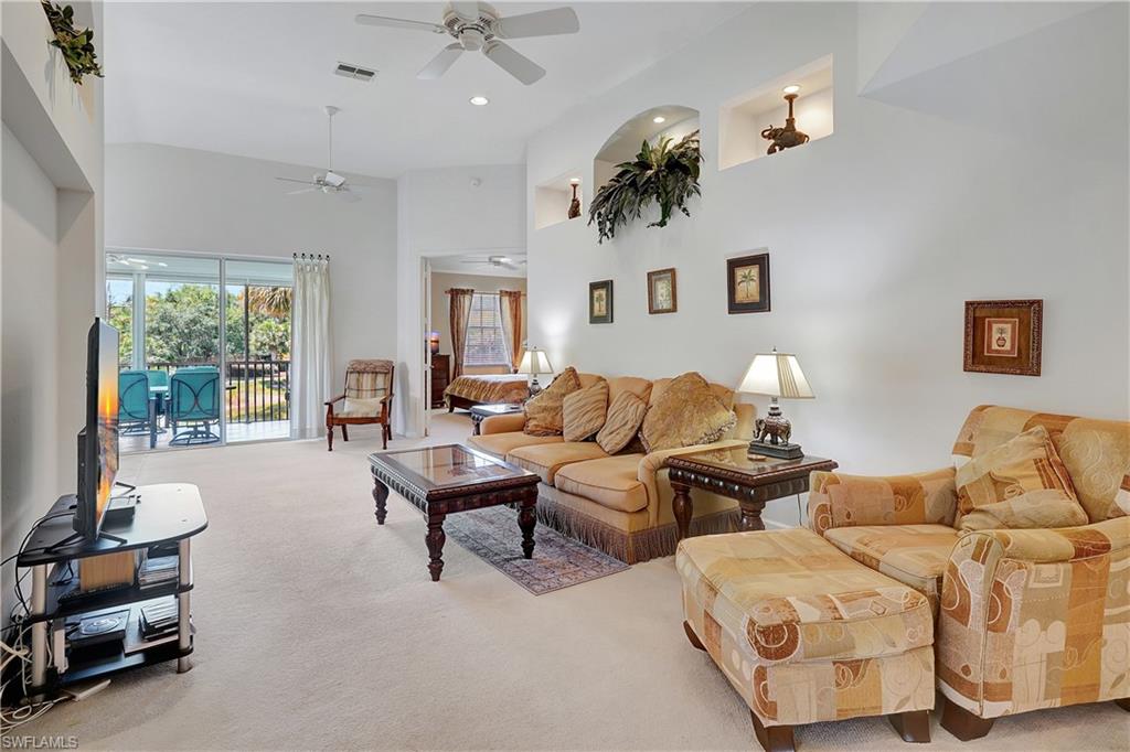 23156 Rosedale Drive, Unit 201 Estero, FL 34135 - Photo 7 of 50 a living room with furniture and a large window