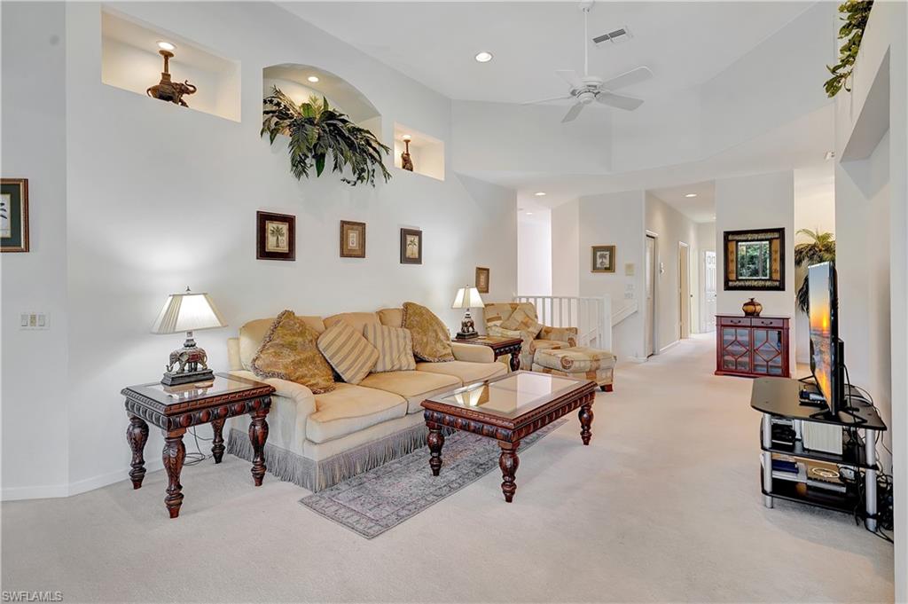23156 Rosedale Drive, Unit 201 Estero, FL 34135 - Photo 8 of 50 a living room with furniture and a flat screen tv