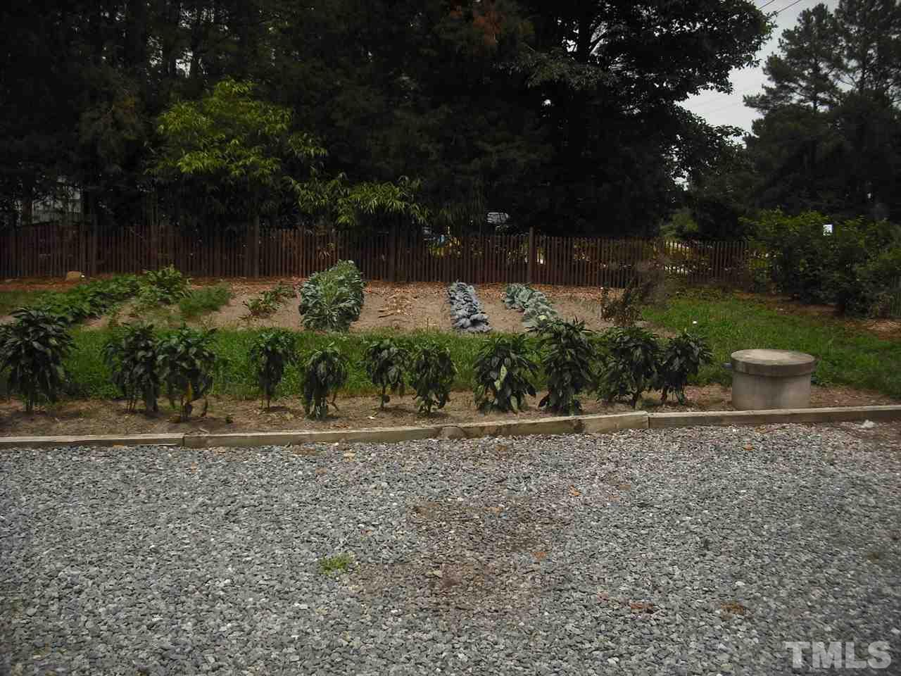 10905 Six Forks Road Raleigh, NC 27614 - Photo 5 of 5 a backyard of a house with lots of green space and lake view