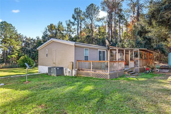 a view of a house with a yard and sitting area