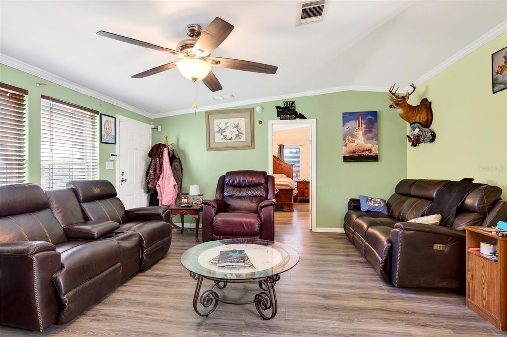 15340 Northwest 65th Avenue Road Reddick, FL 32686 - Photo 12 of 45 a living room with furniture and a wooden floor