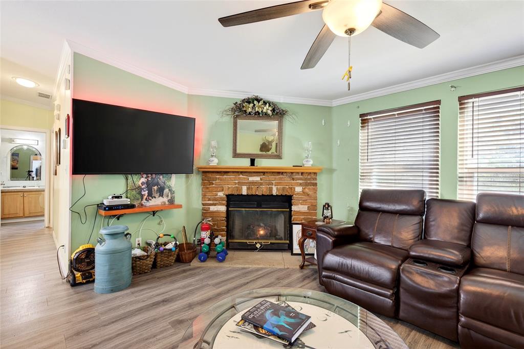 15340 Northwest 65th Avenue Road Reddick, FL 32686 - Photo 15 of 45 a living room with furniture a flat screen tv and a fireplace