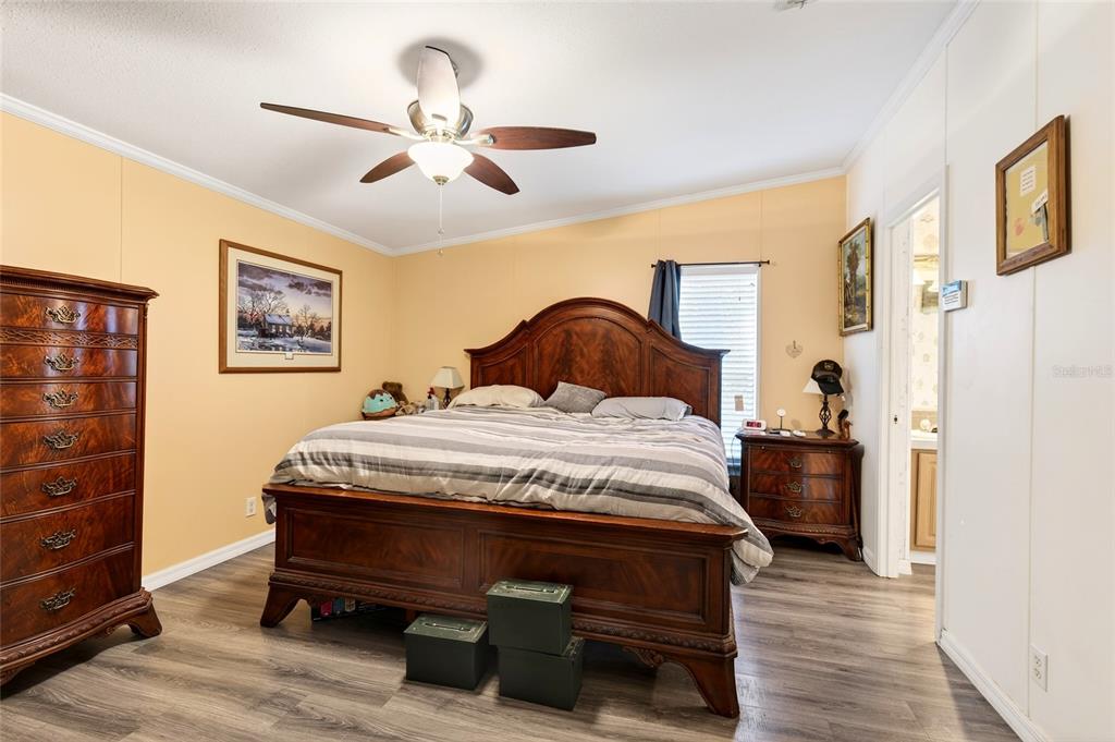 15340 Northwest 65th Avenue Road Reddick, FL 32686 - Photo 16 of 45 a bedroom with a bed and wooden floor